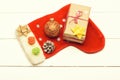 Colorful Christmas or New Year decoration include gift with rose string, yellow bow, Santa Claus red sock, red ball