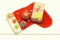 Colorful Christmas or New Year decoration include gift with rose string, yellow bow, Santa Claus red sock, red ball