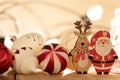 Colorful Christmas ornament balls with small wooden deer and Santa Claus figurines on the table Royalty Free Stock Photo