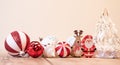 Colorful Christmas ornament balls with small wooden deer and Santa Claus figurines on the table Royalty Free Stock Photo