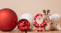 Colorful Christmas ornament balls with small wooden deer and Santa Claus figurines on the table Royalty Free Stock Photo