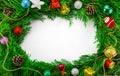 Colorful Christmas ornaments on fir tree branches isolated on white background. Circle Christmas frame and New Year decoration Royalty Free Stock Photo