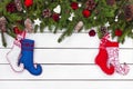 Colorful Christmas socks and fir tree on white wooden background. Top view, copy space Royalty Free Stock Photo