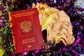Colorful Christmas tinsel, passport citizen of Russia and big shell
