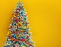 Colorful Christmas tree on yellow background