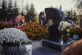Colorful Chrysanthemums Decorate The Tombstones In The Cemetery. Floral Decoration On A Tomb Stone. Autumn Scene