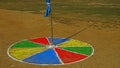 Colorful circle on earthen field or play ground around a wooden post.