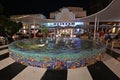 Colorful circular fountain on Lincoln Road Mall in Miami Beach, Florida at night.