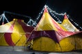 colorful circus tent in the city at night against the sky