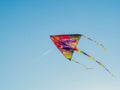 Colorful Cite Flying In The Wind Blue Sky. Flying A Kite Up High Royalty Free Stock Photo