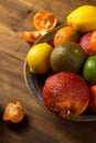 colorful citrus fruits on the bowl, rustic still life