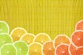 Colorful citrus slice on yellow bamboo texture Royalty Free Stock Photo