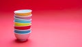 Colorful clean ceramic bowls stacked on red color background, copy space Royalty Free Stock Photo