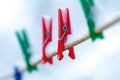 Winter outdoors on a rope hanging clothespins torn by snow Royalty Free Stock Photo