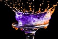 Colorful close-up a drop of violet and orange water is split on the glass in the form of a crown Royalty Free Stock Photo