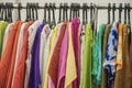 Colorful clothes on hangers for sale in shop. Summer season, assortment in a clothing store. Choice of cotton clothes of Royalty Free Stock Photo