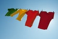 Colorful clothes hanging to dry in the blue sky