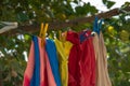 Colorful clothes hanging to dry on a laundry line and sun shining in the blue sky. Royalty Free Stock Photo
