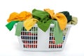 Colorful clothes in laundry basket. Green, yellow. Royalty Free Stock Photo