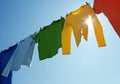 Colorful clothes on a laundry line and sun shining Royalty Free Stock Photo