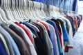 Colorful clothes on multiple hangers in a clothing secondhand store