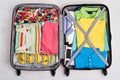 Colorful clothes in opened suitcases.