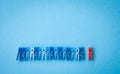 Colorful clothes pegs on blue