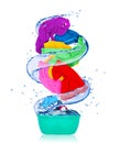 Colorful clothes rotates in a swirl and flying out from bowl Royalty Free Stock Photo