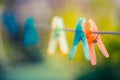 Colorful clothespin hanging on rope, depth of field Royalty Free Stock Photo