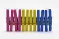 colorful clothespin standing in a row on an isolated white surface Royalty Free Stock Photo