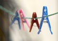 Colorful Clothespins Clipped on a Green Clothesline