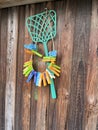 colorful clothespins hang on a wooden fence