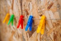 Colorful clothespins hanging on a rope  over a wooden background. Royalty Free Stock Photo