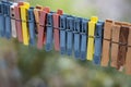 Colorful clothespins outdoor, on the rope over blur background. Royalty Free Stock Photo