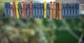 Colorful clothespins outdoor, on the rope over blur background. Royalty Free Stock Photo