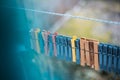 Colorful clothespins outdoor, on the rope over blur background. Royalty Free Stock Photo