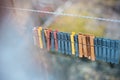 Colorful clothespins outdoor, on the rope over blur background. Royalty Free Stock Photo