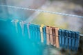 Colorful clothespins outdoor, on the rope over blur background. Royalty Free Stock Photo