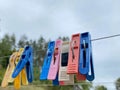 Colorful clothespins outdoor, on the rope over blur background Royalty Free Stock Photo