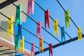 Colorful clothespins on rope of blue sky background. Bright clothespins for drying clothes Royalty Free Stock Photo