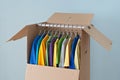 Colorful clothing in a wardrobe box for moving