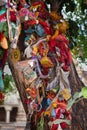 Colorful cloths in holy tree near a temple in India