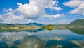 White clouds blue sky beautiful lake with wonderful mirror reflecion Royalty Free Stock Photo