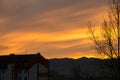 Colorful clouds over the city and buildings or park and meadow, during sunrise or sunset. Royalty Free Stock Photo