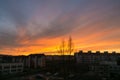 Colorful clouds over the city and buildings or park and meadow, during sunrise or sunset. Royalty Free Stock Photo