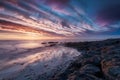 Colorful cloudy sky enhances picturesque seascape beauty