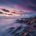 Colorful cloudy sky enhances picturesque seascape beauty