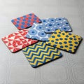 Colorful Coasters with Geometric Patterns on Textured Background for Drinks Royalty Free Stock Photo