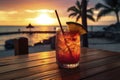 Colorful cocktail or juice in a glass decorated on a wooden table on blurred seascape background