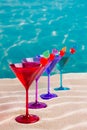 Colorful cocktail in a row with cherry on tropical sand beach Royalty Free Stock Photo